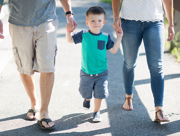 parents walking with a kid